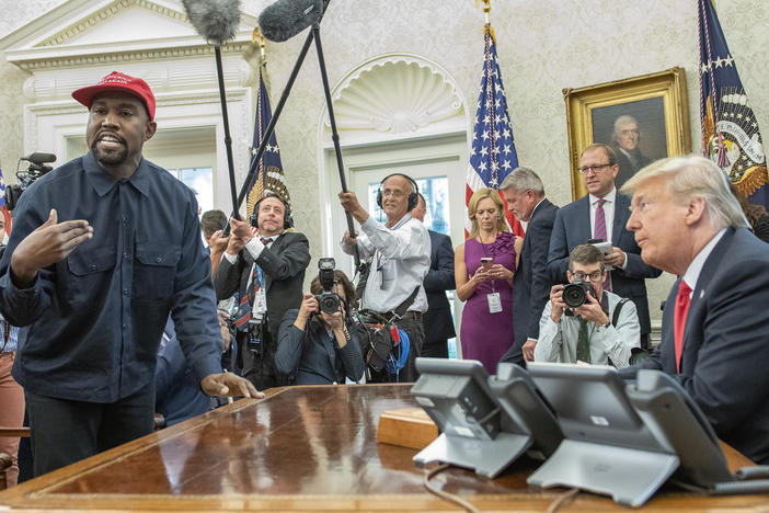 A crowd of White House press looks on as Kanye West and then-President Donald Trump meet in the Oval Office on Oct. 11, 2018.