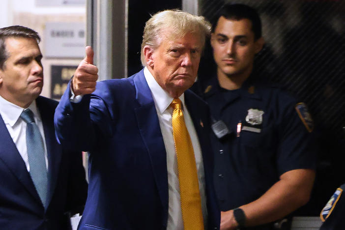 Former U.S. President Donald Trump gives a thumbs up as he returns to the courtroom after a break in his trial for allegedly covering up hush money payments at Manhattan Criminal Court on May 2, 2024 in New York City.