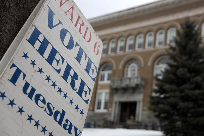 A "Vote Here Tuesday" sign is seen in Burlington, Vt., in 2020. In 2023, the city voted to allow non-U.S. citizens who are in the country legally to vote in local elections. But their turnout remains low.