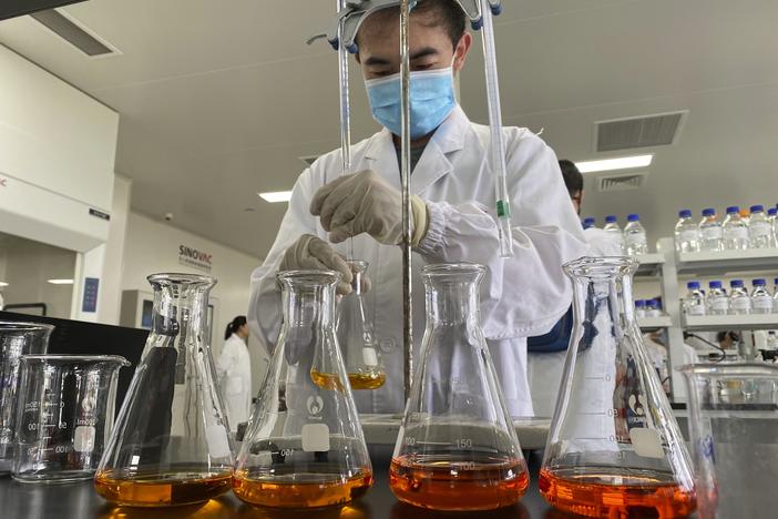 A worker works inside a lab at the SinoVac vaccine factory in Beijing on Thursday, Sept. 24, 2020. SinoVac, one of China's pharmaceutical companies behind a leading COVID-19 vaccine candidate, says its vaccine will be ready by early 2021 for distribution worldwide, including the U.S.