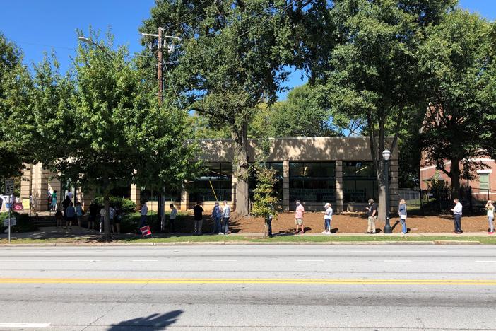 Voters stand outside Fulton County Library System's Ponce De Leon Branch to vote during the first week of in-person early voting.