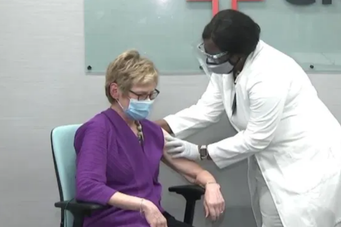 DPH Commissioner Dr. Kathleen Toomey receives a COVID-19 vaccine.