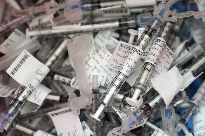 A pile of vaccine syringes.