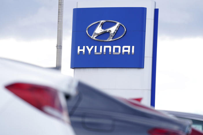 The Hyundai company logo hangs over a long row of cars at a car dealership in Centennial, Colo., Sunday, Dec. 20, 2020. Georgia officials are close to finalizing a deal with the automaker to build a $5.5 billion electric car plant near Savannah, Ga. An economic development agency representing four Savannah-area counties approved its portions of the agreement Tuesday, July 19, 2022, including an economic incentives package.