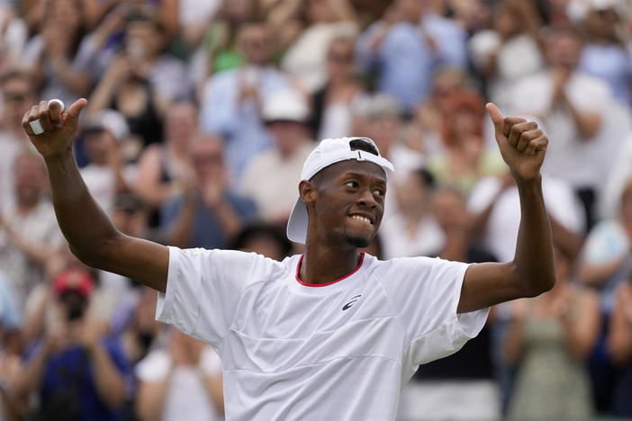 Christopher Eubanks of the US celebrates after beating Stefanos Tsitsipas of Greece in a men's singles match on day eight of the Wimbledon tennis championships in London, Monday, July 10, 2023. 