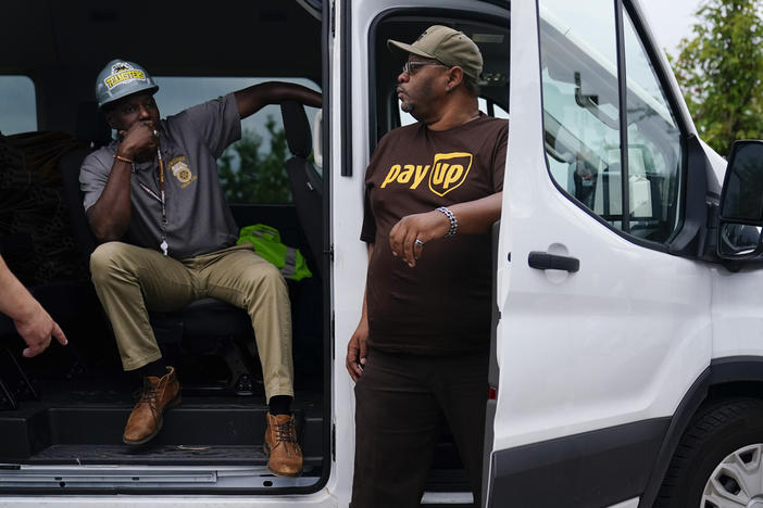 UPS teamsters and workers wait before a rally, Friday, July 21, 2023, in Atlanta, as a national strike deadline nears. The Teamsters said Friday that they will resume contract negotiations with UPS, marking an end to a stalemate that began two weeks ago when both sides walked away from talks while blaming each other.