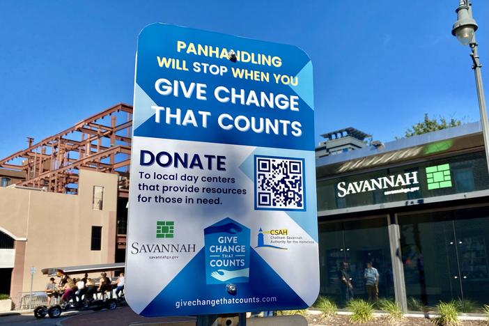 A sign posted near Ellis Square in downtown Savannah is part of a campaign by the city and a local homelessness nonprofit to solicit donations for four day centers.
