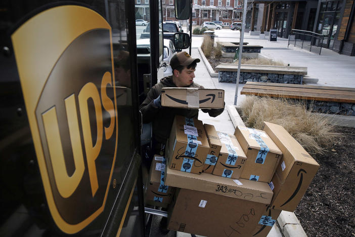 A UPS driver prepares to deliver packages in Baltimore, Md., Dec. 19, 2018. UPS plans to hire more than 100,000 workers — at higher pay than a year ago — to help handle the holiday rush this season, in line with hiring the previous three years.