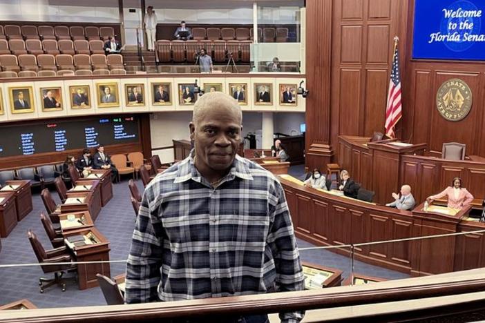 In this photo provided by the Innocence Project of Florida, Leonard Allen Cure poses from the floor of the Florida legislature in Tallahassee, Fla., in April 2023, on the day his compensation bill was passed. Cure, who spent more than 16 years in prison in Florida on a wrongful conviction, was shot and killed Monday, Oct. 156, by a sheriff's deputy in Georgia during a traffic stop, authorities and representatives said.
