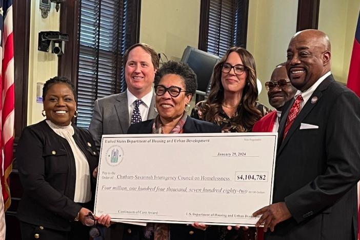 U.S. Secretary of Housing and Urban Development Marcia Fudge, center, presents a ceremonial check at Savannah City Hall, corresponding to $4.1 million in HUD funding for the Chatham-Savannah Interagency Council on Homelessness.