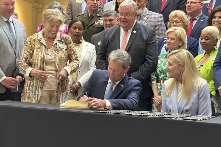 Georgia Gov. Brian Kemp signs the budget for the year beginning July 1, 2024 at the state capitol in Atlanta on Tuesday, May 7, 2024. Kemp says the document shows Georgia can boost spending and cut taxes at the same time.