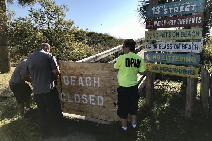 Tybee Island workers close access to the beach after Mayor Session's order.