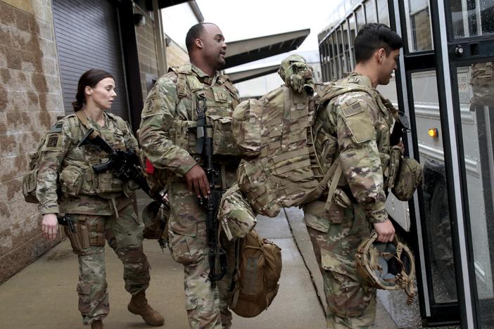U.S. Army soldiers board a bus in January 2020 at Fort Bragg, N.C., one of the military bases that will likely see population boosts in their 2020 census counts due to a change to how troops deployed abroad were counted.