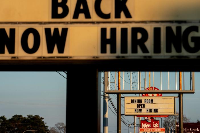 Signs with the message 'Now Hiring' are displayed in front of restaurants in Rehoboth Beach, Delaware, on March 19.