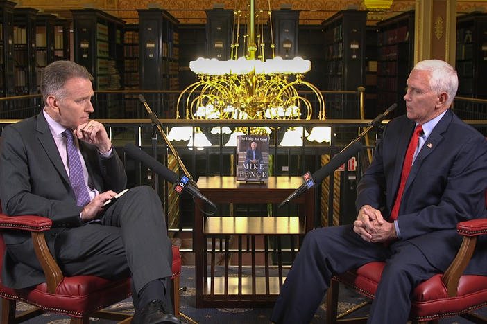 Former Vice President Mike Pence (right) speaks with <em>Morning Edition</em> co-host Steve Inskeep at the law library of the Indiana state capitol in Indianapolis on Monday.