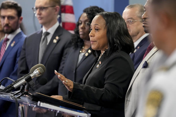 Fulton County District Attorney Fani Willis, center, during a news conference on Aug. 14.