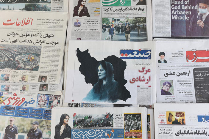 Newspapers with a cover picture of Mahsa Amini, a woman who died after being arrested by Iran's morality police, are seen in Tehran, Sept. 18, 2022.