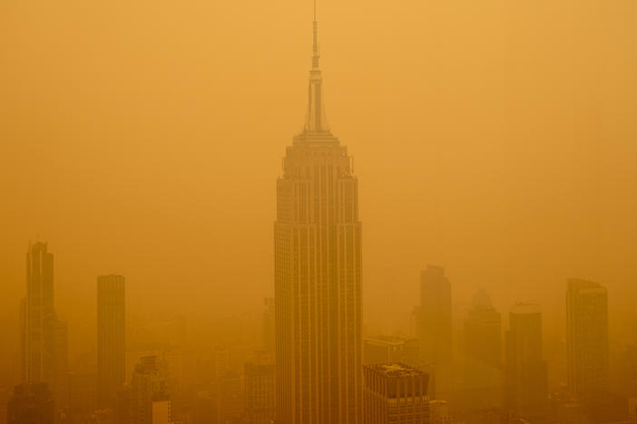 Smoky haze from wildfires in Canada obscures New York City's Empire State Building this year. The air in the U.S. has improved over the past 50 years, but smoke pollution from growing wildfires erodes much of that progress.