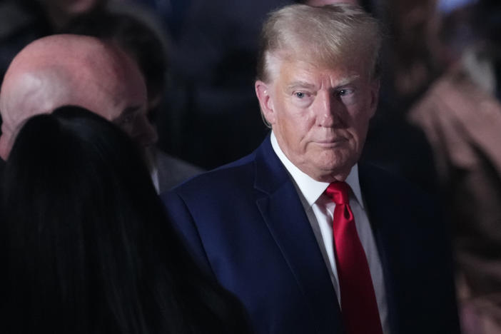 Former President Donald Trump, shown here at a mixed martial arts event on Nov. 11, is asking to be freed from a gag order in an election interference case.