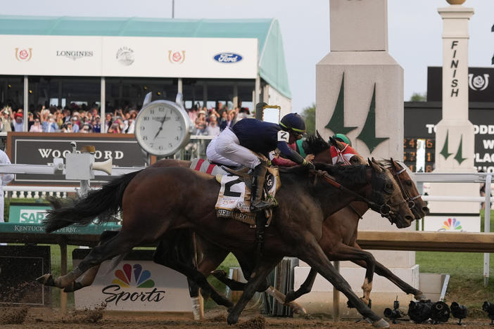 Sierra Leone, with jockey Tyler Gaffalione, (2), Forever Young, with jockey Ryusei Sakai, and Mystik Dan, with jockey Brian Hernandez Jr., cross the finish line at Churchill Downs during the 150th running of the Kentucky Derby horse race Saturday, in Louisville, Ky.
