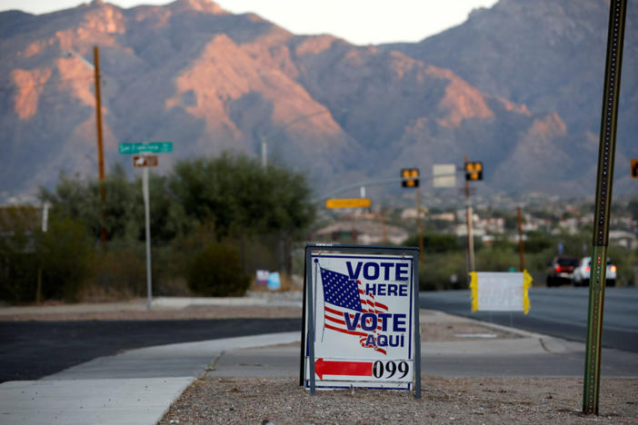 FILE PHOTO: Sign directs voters to a polling station on Election Day in Tucson, Arizona, U.S. November 3, 2020. REUTERS/Cheney Orr/File Photo