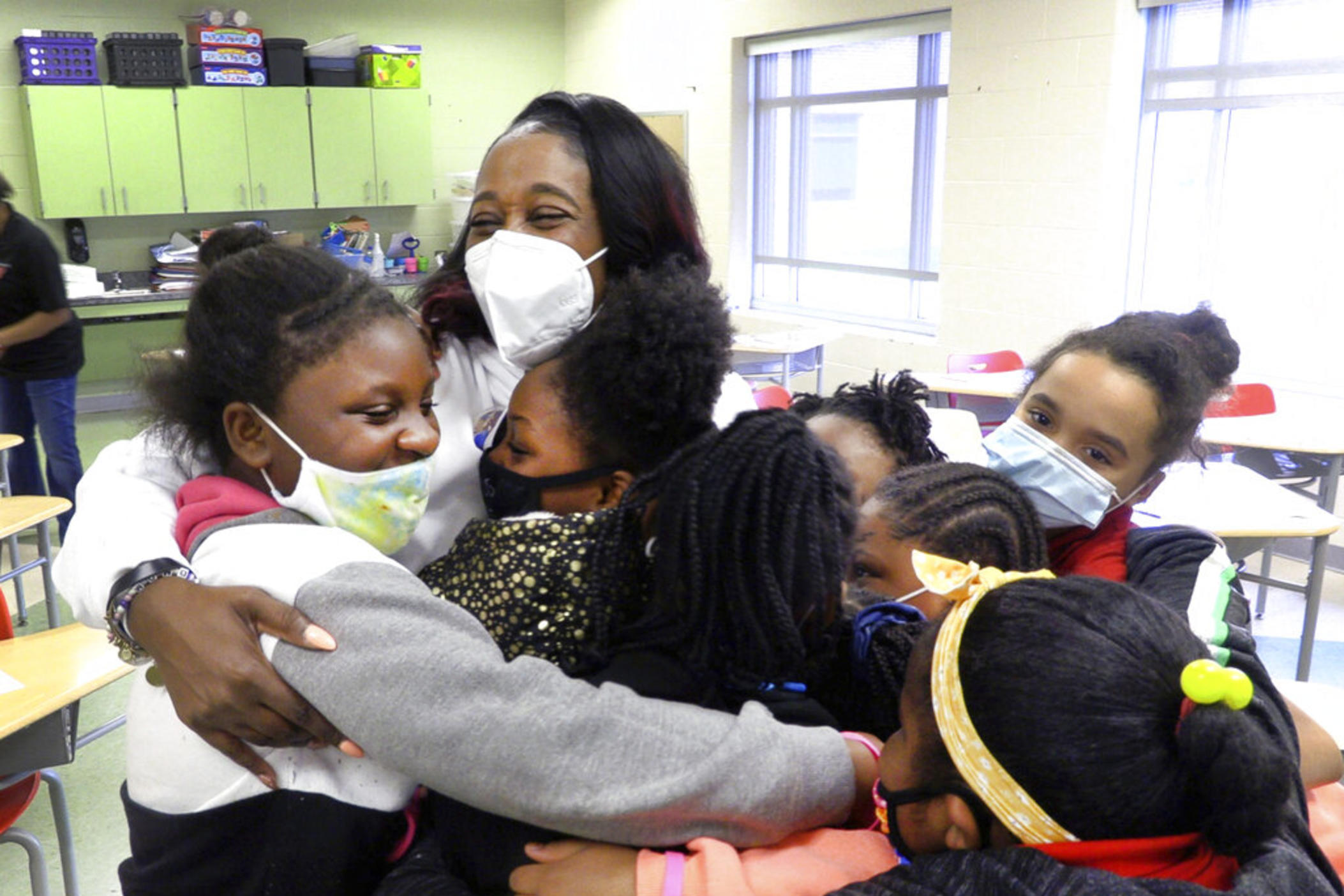 Shameika Averett, founder of Gigi's PEARLS, Inc., hugs students at Dorothy Height Elementary School on Jan. 14, 2021, in Columbus, Ga., after he first meeting of Gigi's PEARLS. Six years after her daughter, mother and brother were murdered in a triple homicide, Averett created the nonprofit organization to help Columbus area girls become successful women who are constructive citizens in their community — and don’t tolerate violence.