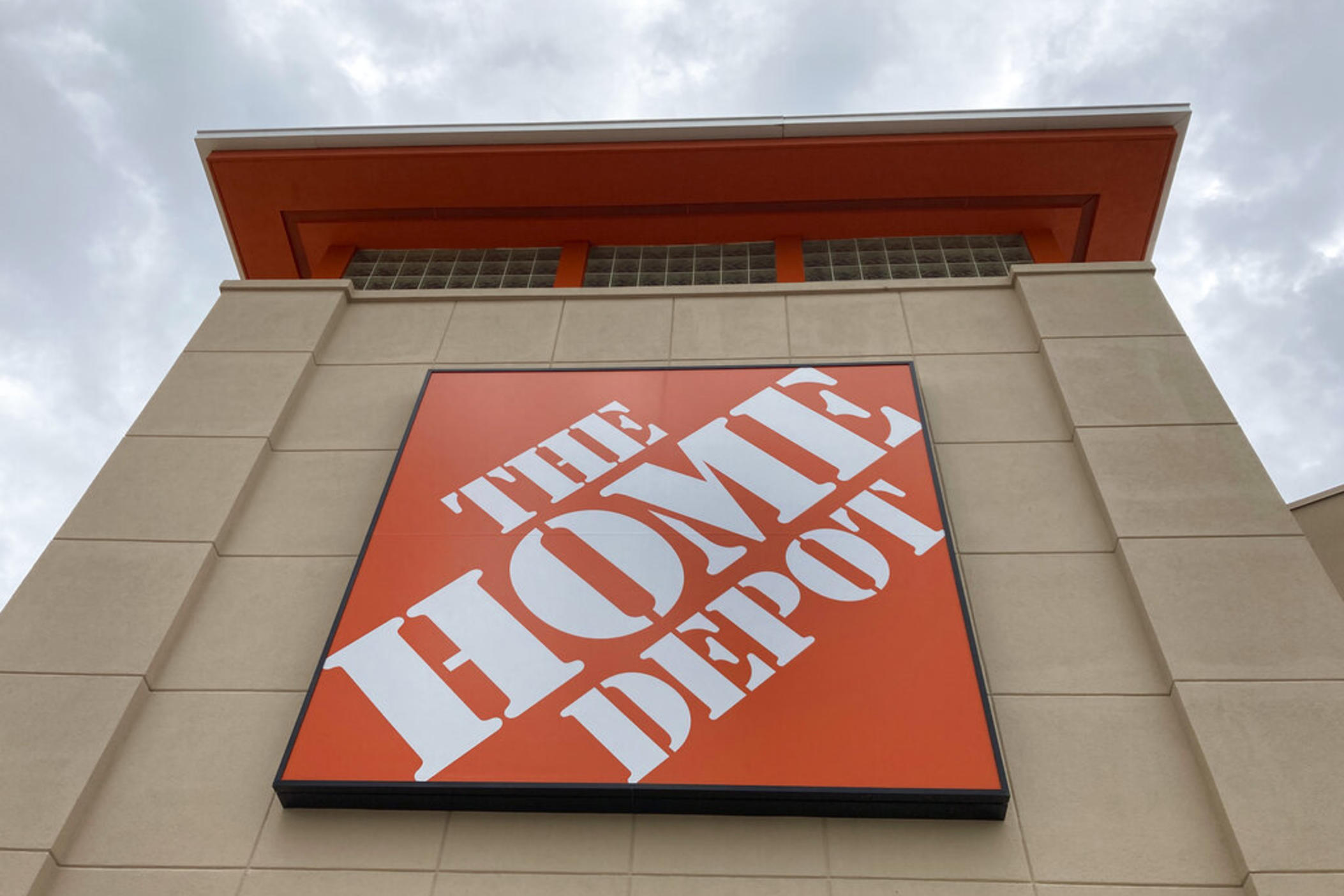 A Home Depot logo sign hands on its facade, Friday, May 14, 2021, in North Miami, Fla. Home Depot reports their financial earnings on Tuesday, Feb. 21, 2023.