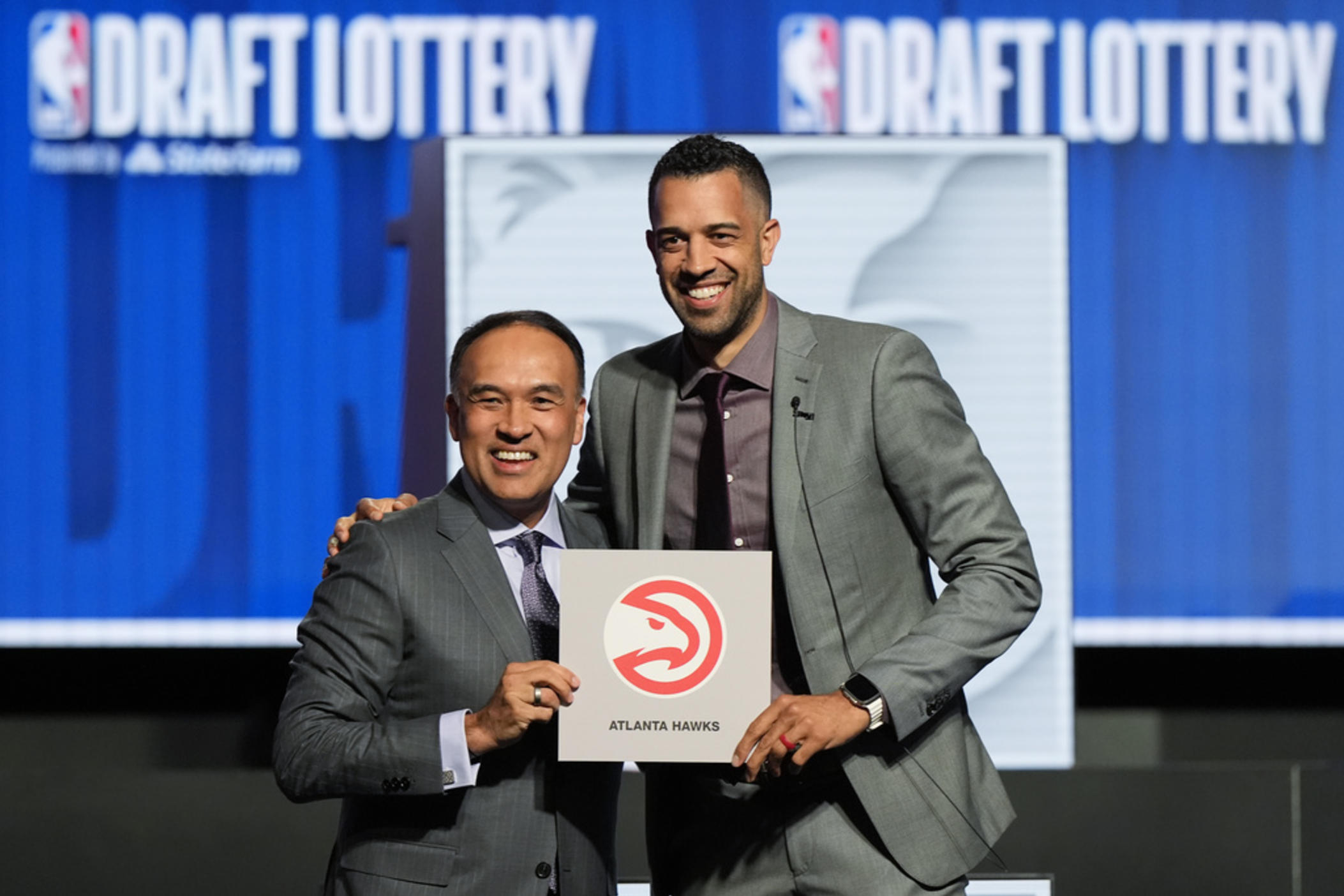 Atlanta Hawks general manager Landry Fields, right, and NBA Deputy Commissioner Mark Tatum pose for photos after Tatum announced that the Hawks had won the first pick in the NBA draft, during the draft lottery in Chicago, Sunday, May 12, 2024. 