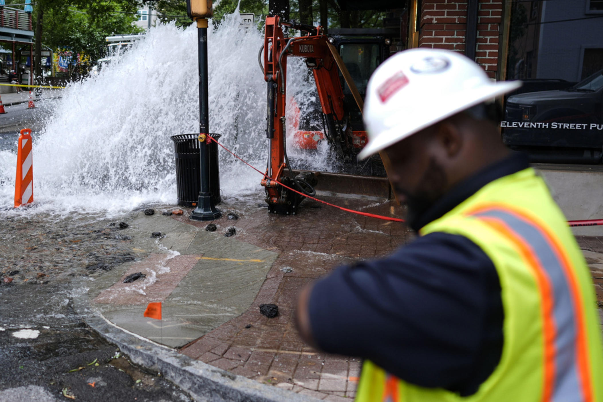 A crew member walks near a broken water transmission line, Saturday, June 1, 2024, in Atlanta. Much of Atlanta, including all of downtown, has been without water since Friday afternoon after crews began work to repair breaks on transmission lines in the downtown area.