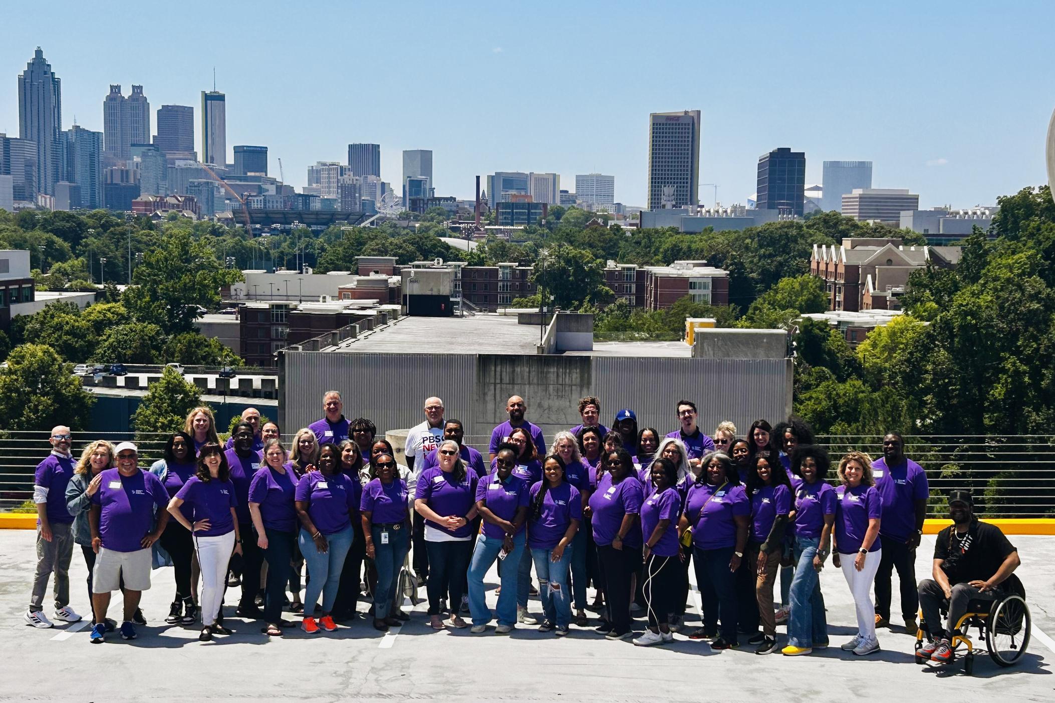 GPB Student Voices Collective workshop participants in front of the Atlanta skyline