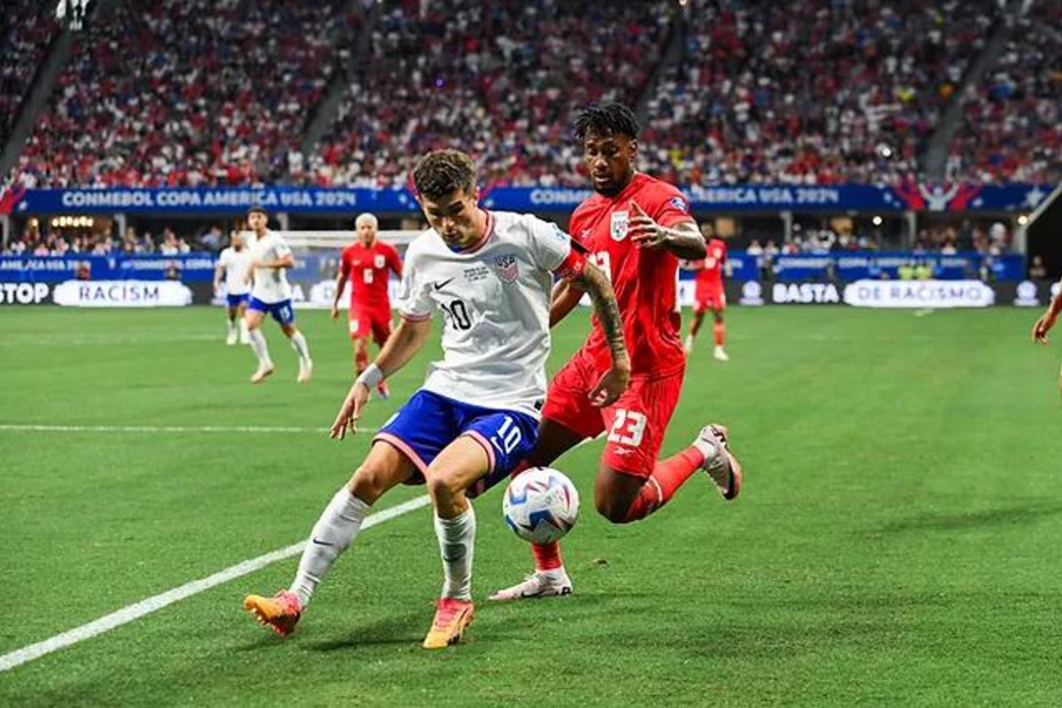 U.S. Men's National Team captain Christian Pulisic (center) pursues the ball with Panama's  Michael Murillo right behind him at the June 27 Copa America match at Atlanta's Mercedes-Benz Stadium.
