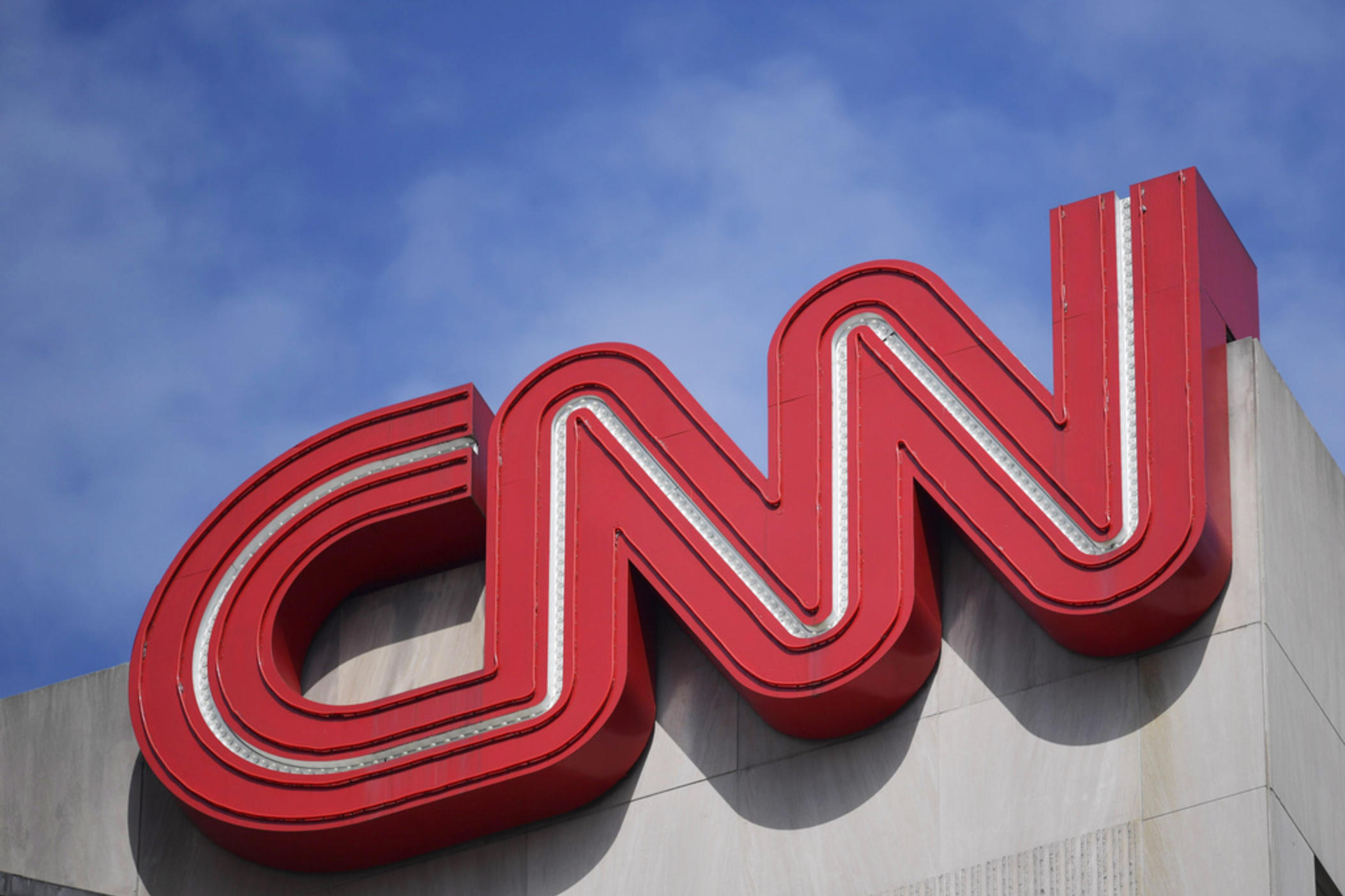 The CNN sign is seen, April 21, 2022, in Atlanta. CNN announced Wednesday, July 10, 2024, that it is eliminating approximately 100 jobs and plans to debut its first digital subscriptions before the end of the year as the news network leans into reshaping its business. 