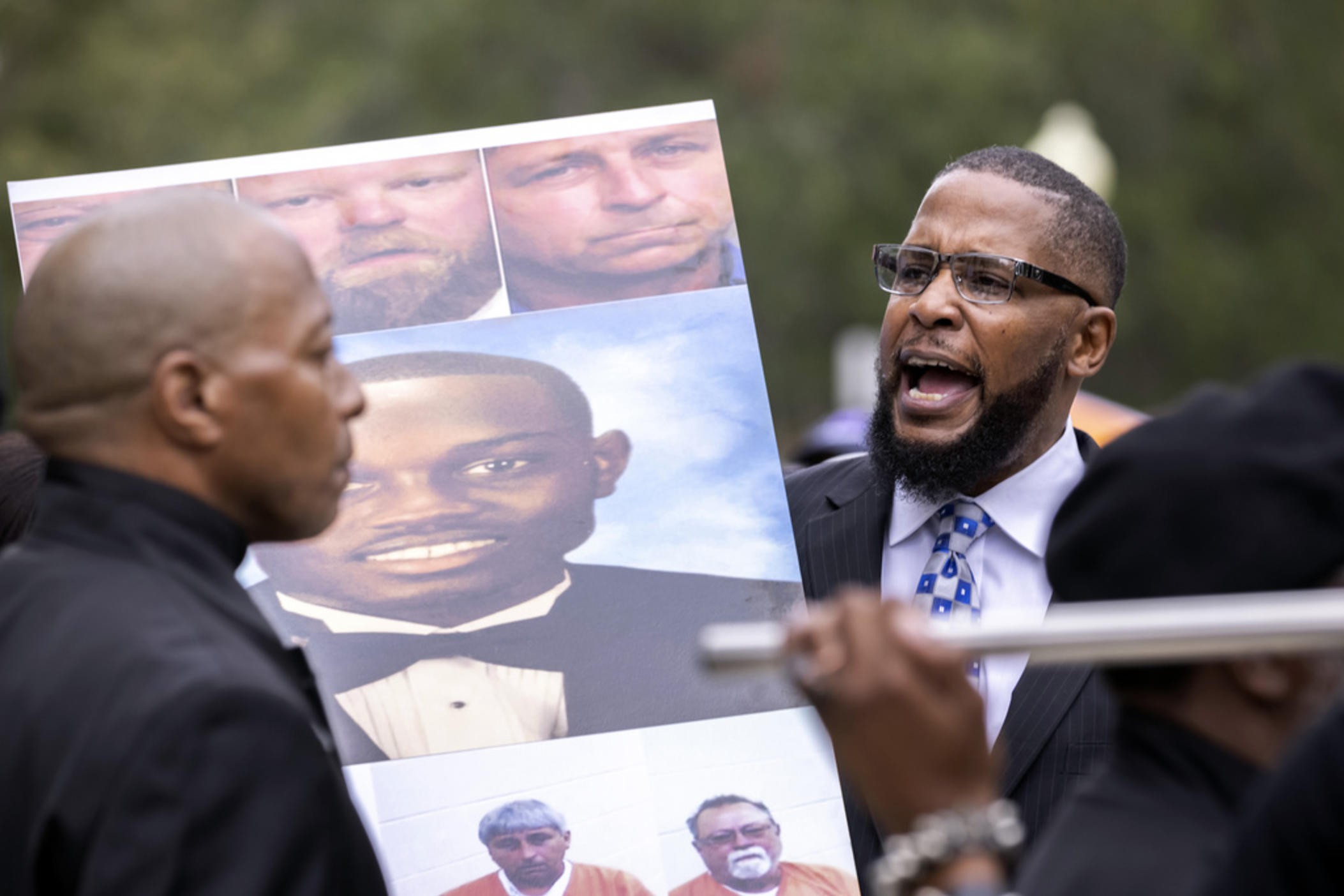 Dozens of Black Lives Matter and Black Panther protesters gather outside the Glynn County Courthouse where the trial of Travis McMichael, his father, Gregory McMichael, and William "Roddie" Bryan is held, Nov. 22, 2021, in Brunswick, Ga. 