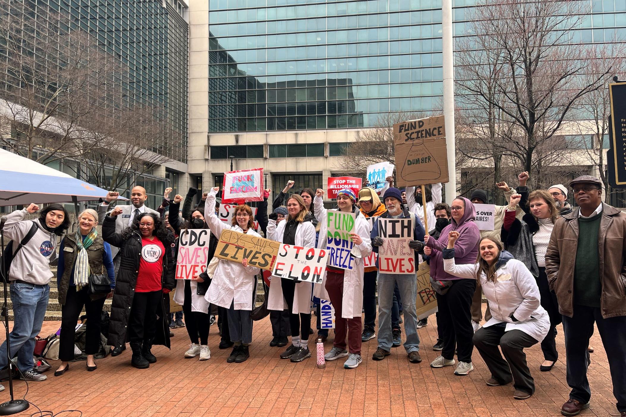 Researchers and university workers rally in downtown Atlanta on February 19, 2025 to protest federal grant freezes from the Trump Administration affecting campus funding. 