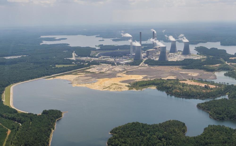 Georgia Power's Plant Scherer has a coal ash pond, foreground, where residuals from burning coal at the plant are stored. The pond goes to depths of 80 feet in some places and comes into contact with groundwater.