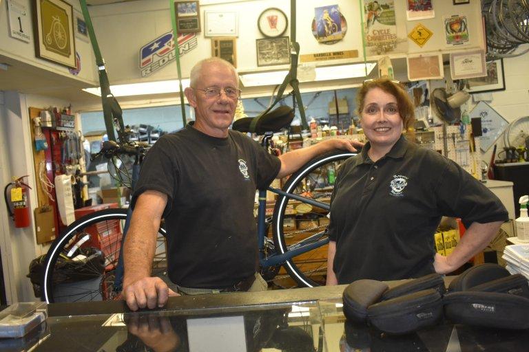 Mikki and Allen Griffin stand behind the counter of Perpetual Motion Bicycles in Carrollton.