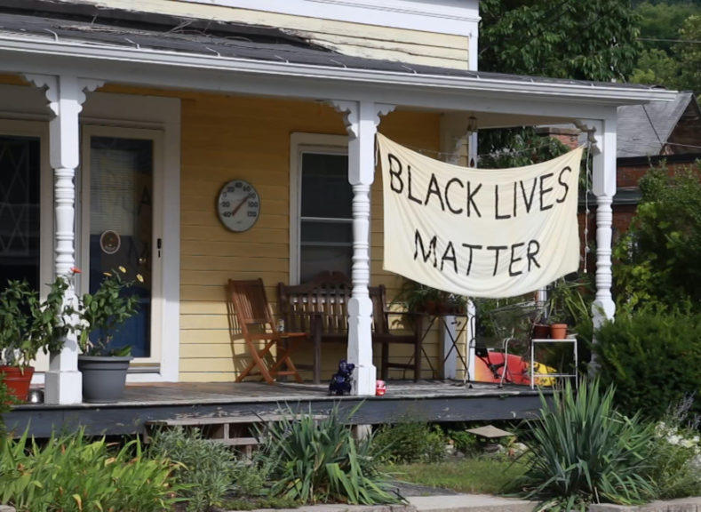 A black lives matter sign on a house.