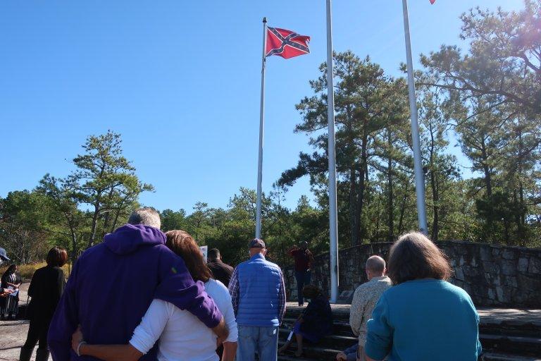 A "prayer for our park" event was held Tuesday as advocates press for the removal of Confederate flags from the park and other changes.