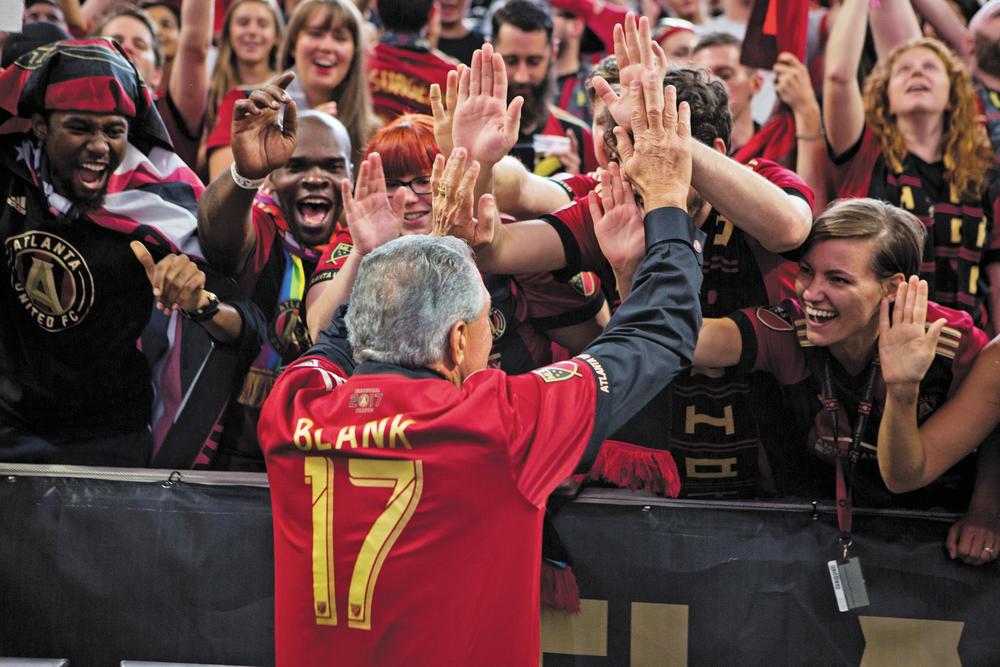 Arthur Blank greets a crowd of cheering Atlanta United fans in 2017.   Photo credit: AJ Reynolds/AMBSE Creative