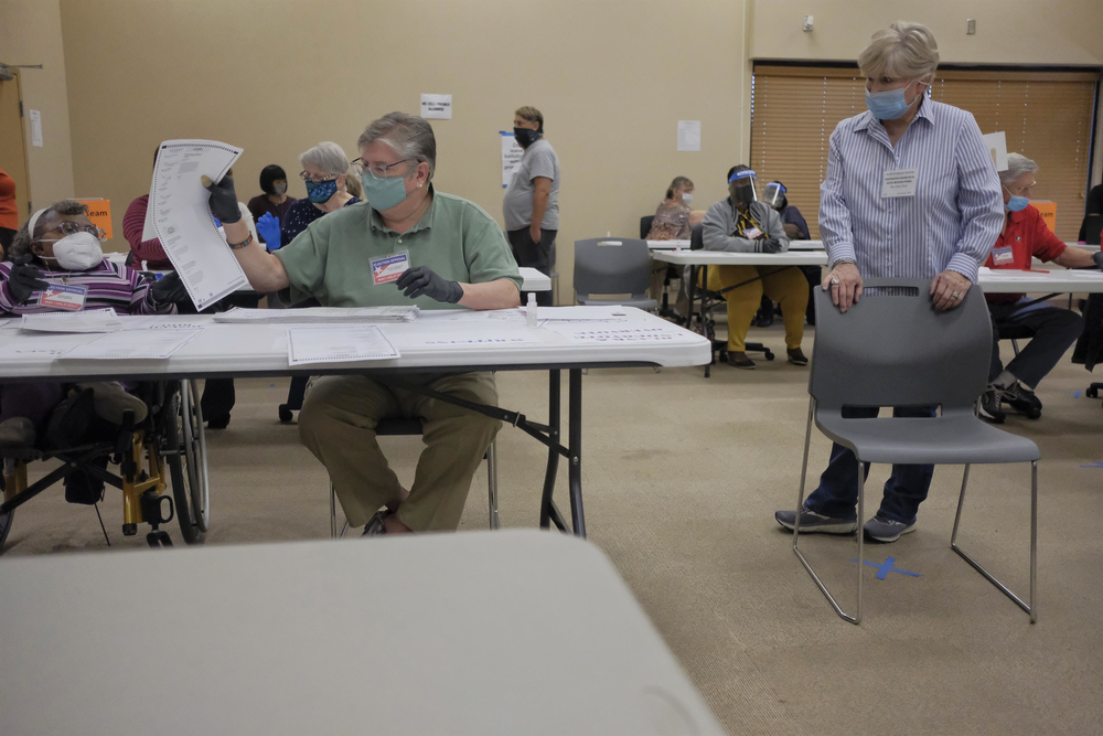 A Republican Party poll watcher keeps an eye on the recount in Macon Friday. There were two poll watchers for seven teams of auditors.