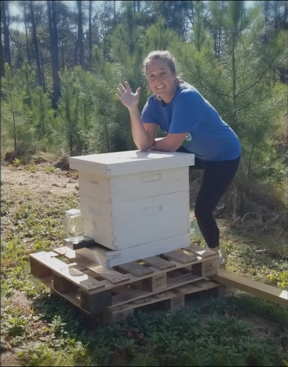 Riverwood International Charter School teacher Patti Lawrimore pictured with one of the school's beehives.