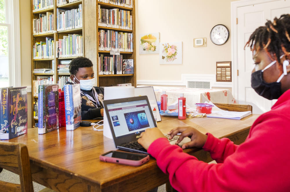 Siblings Quinyonna Tooks, right, and Charles Knott do their schoolwork in the Oglethorpe Library in Macon County. Charles is not a fan of remote learning. “I don't like it,” he said. “In school is better for me. I can focus in there with the teachers.”