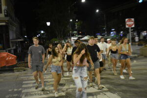  As the commission voted to institute a mask mandate, unmasked young people crowded the streets of Athens.