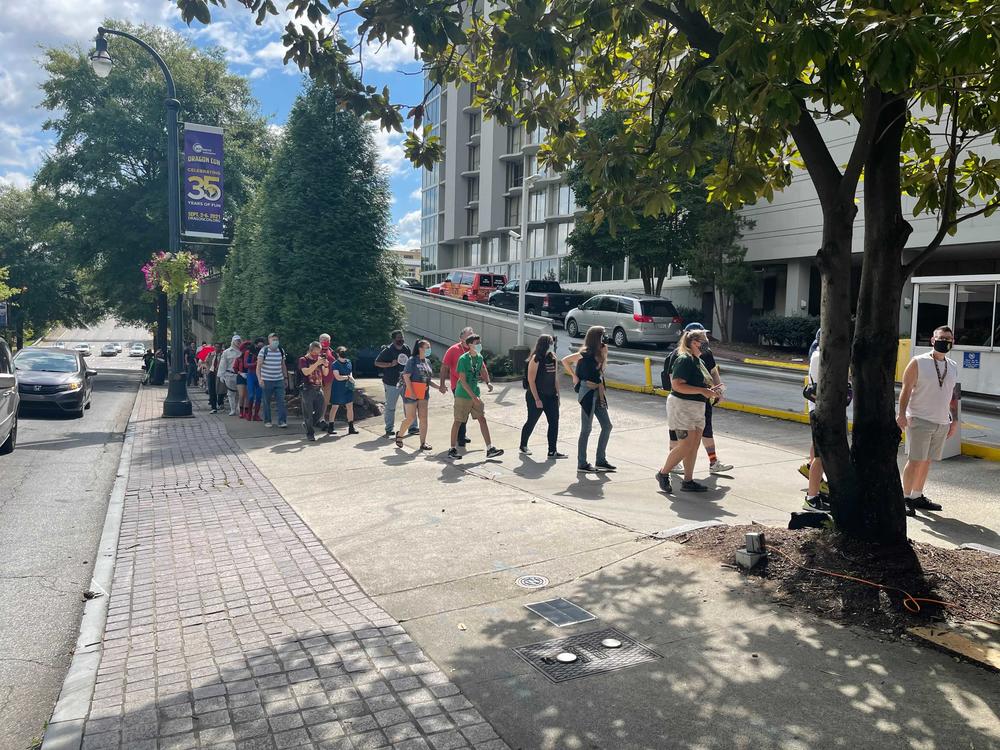 Attendees wait in line Thursday for admission to Dragon Con 2021.