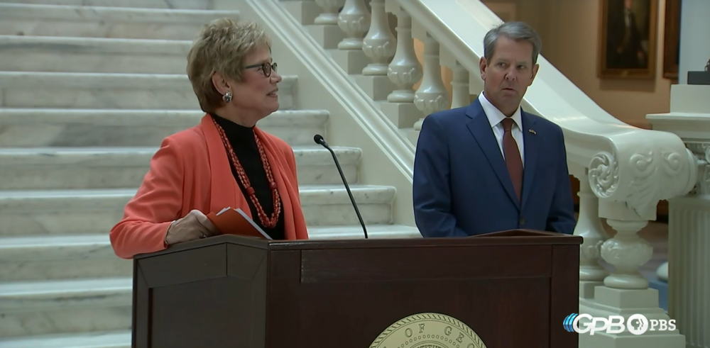 DPH Commissioner Dr. Kathleen Toomey and Gov. Brian Kemp stand at a podium in the Georgia Capitol Sept. 30, 2021.