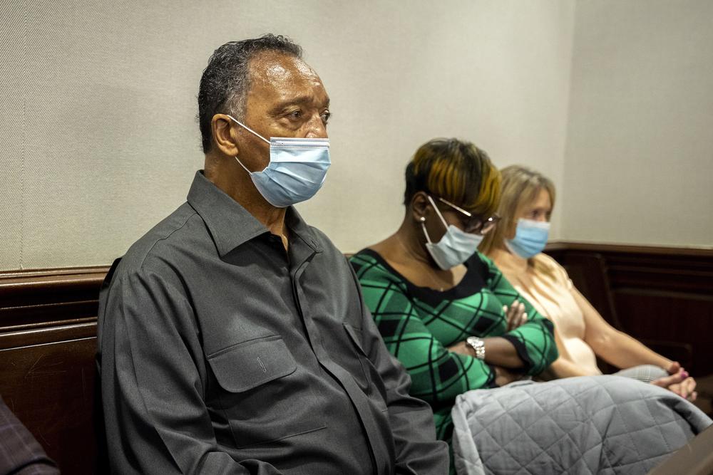The Rev. Jesse Jackson, left, sits with Ahmaud Arbery's mother, Wanda Cooper-Jones, center, during the trial of Greg McMichael and his son, Travis McMichael, and a neighbor, William "Roddie" Bryan in the Glynn County Courthouse, Monday, Nov. 15, 2021, in Brunswick, Ga.