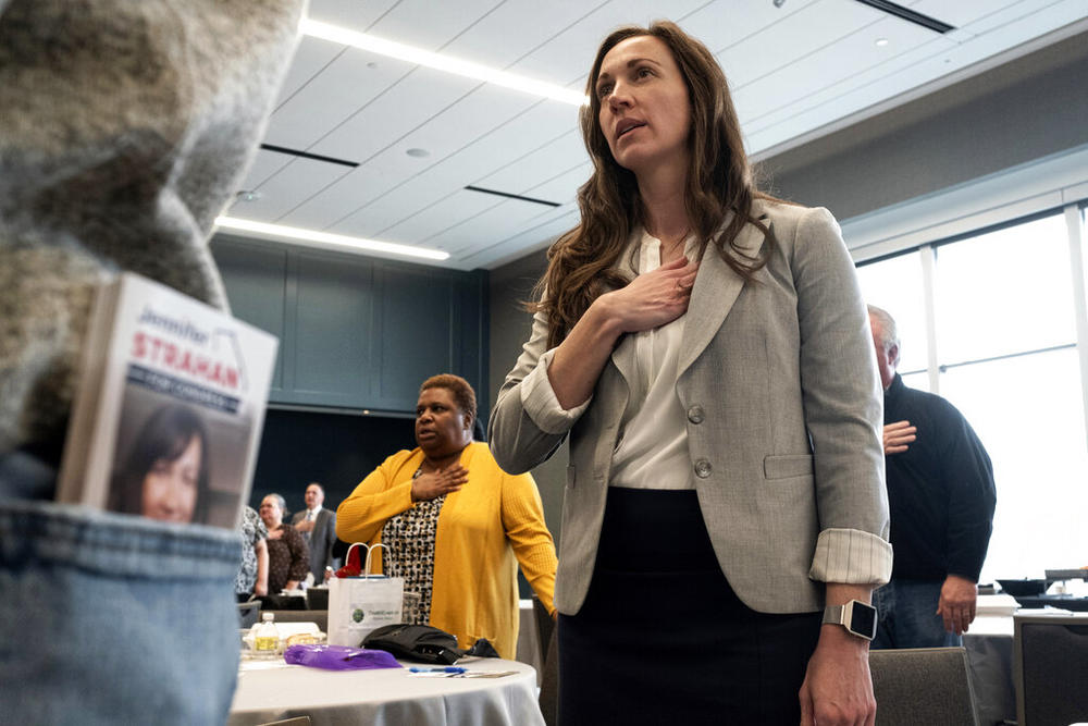 Jennifer Strahan, who is running for Congress in Georgia's 14th district, recites the Pledge of Allegiance at a Paulding County Chamber of Commerce luncheon in Hiram, Ga., on Thursday, Feb. 3, 2022. Strahan is among the candidates challenging Republican Marjorie Taylor Greene in Georgia's May 24 primary.