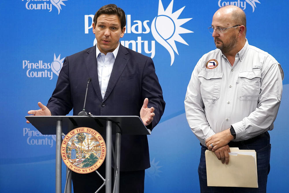 Florida Gov. Ron DeSantis, left, speaks as he stands with Kevin Guthrie, director of the Florida Division of Emergency Management, during a news conference, Monday, Sept. 26, 2022, in Largo, Fla. DeSantis was keeping residents updated on the track of Hurricane Ian.