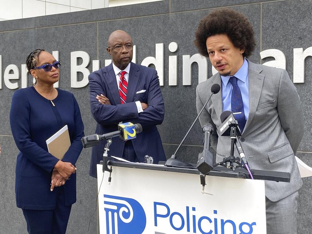 Comedian Eric André, right, speaks at a news conference outside the federal courthouse in Atlanta on Tuesday, Oct. 11, 2022, as his attorneys Allegra Lawrence-Hardy, left, and Richard Deane watch. André and comedian Clayton English filed a lawsuit Tuesday alleging that they were racially profiled and illegally stopped by Clayton County police at Hartsfield-Jackson Atlanta International Airport.