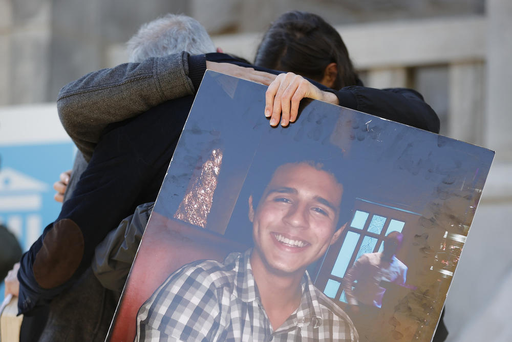 Family members of Manuel Esteban Paez Terán embrace during a news conference, Monday, March 13, 2023, in Decatur, Ga.